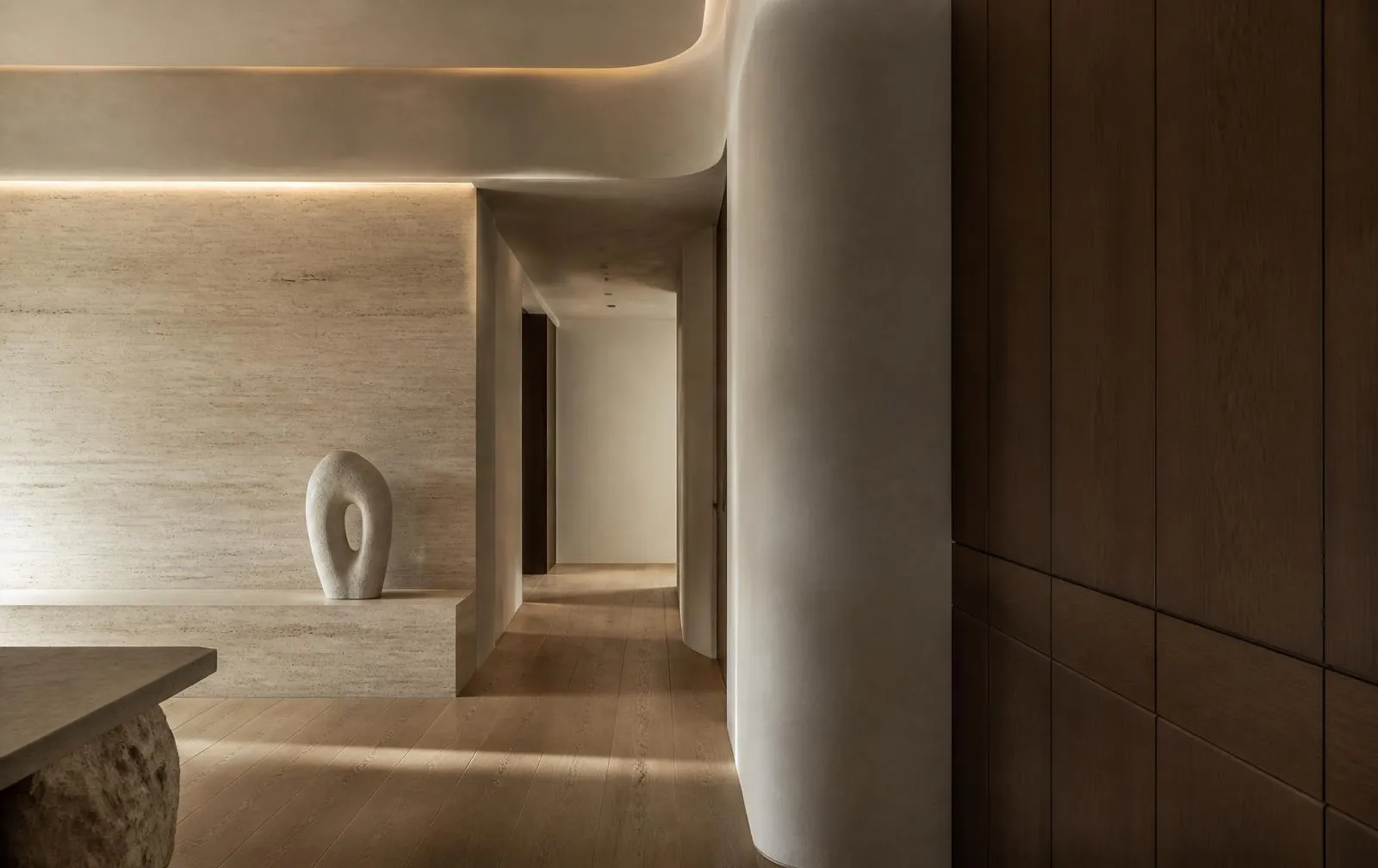 Minimal travertine and oak interior with concealed lighting